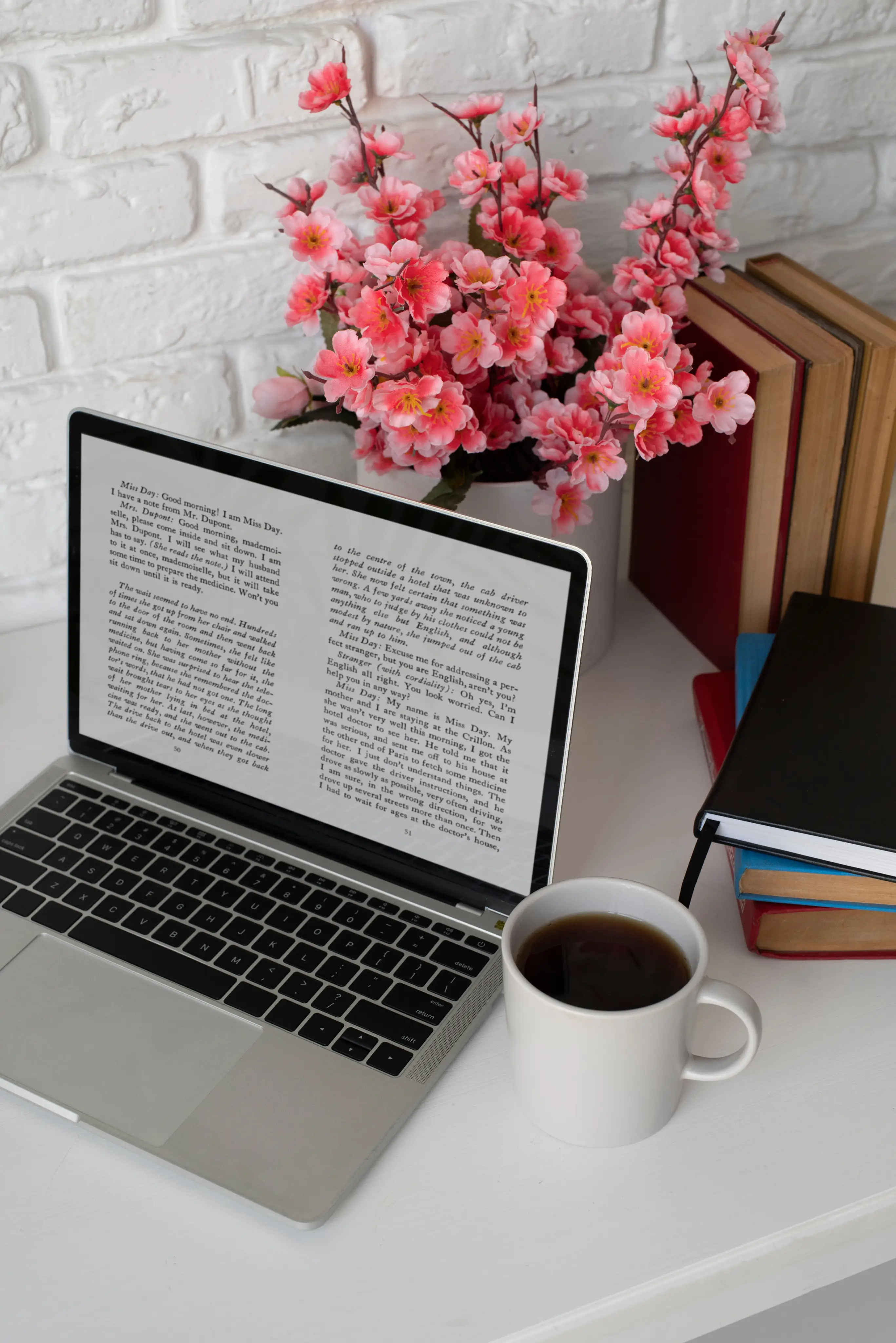 Laptop, coffee and books on a desk